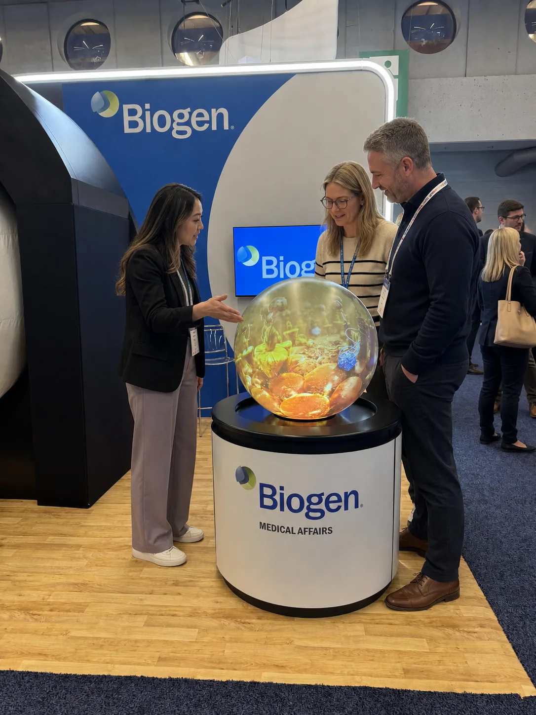 Delegates interacting with a branded spherical display at a healthcare conference