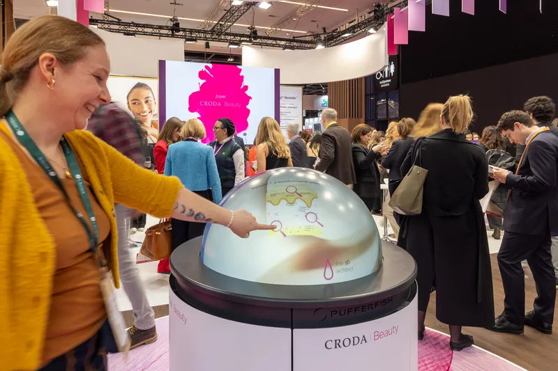 Visitor interacting with Croda's PufferTouch Hemi at in-cosmetics global 2026