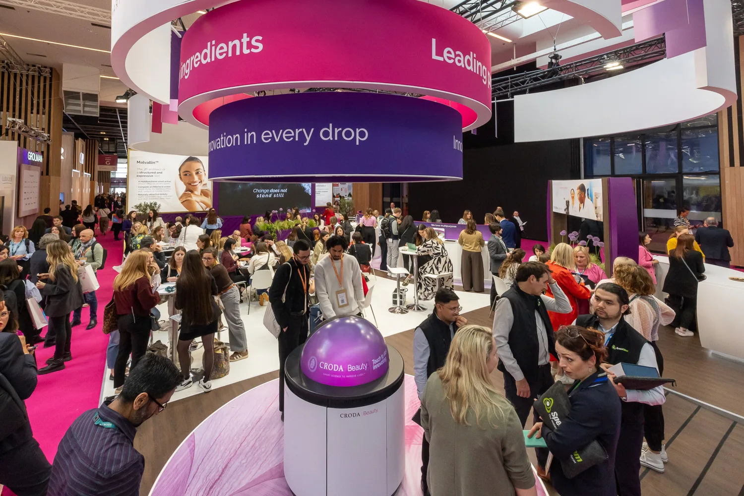 Visitors gathering around Croda's display at in-cosmetics global