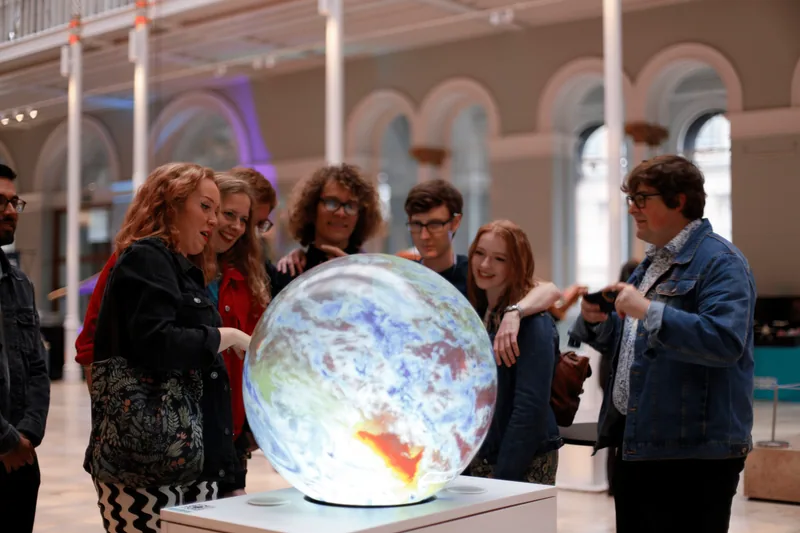 Visitors actively engaging together with a real Pufferfish interactive display
