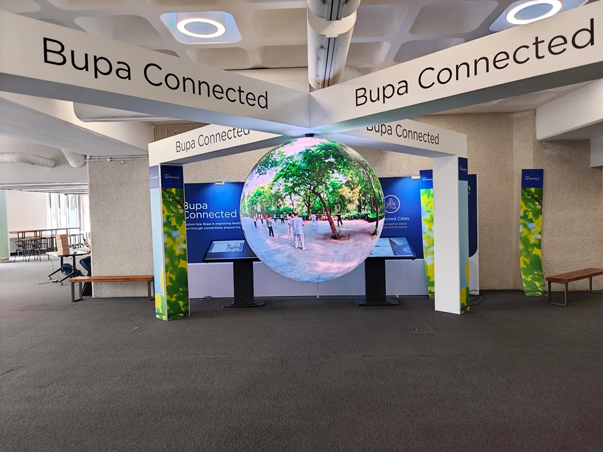 The suspended Bupa Connected LED sphere showing a green outdoor scene