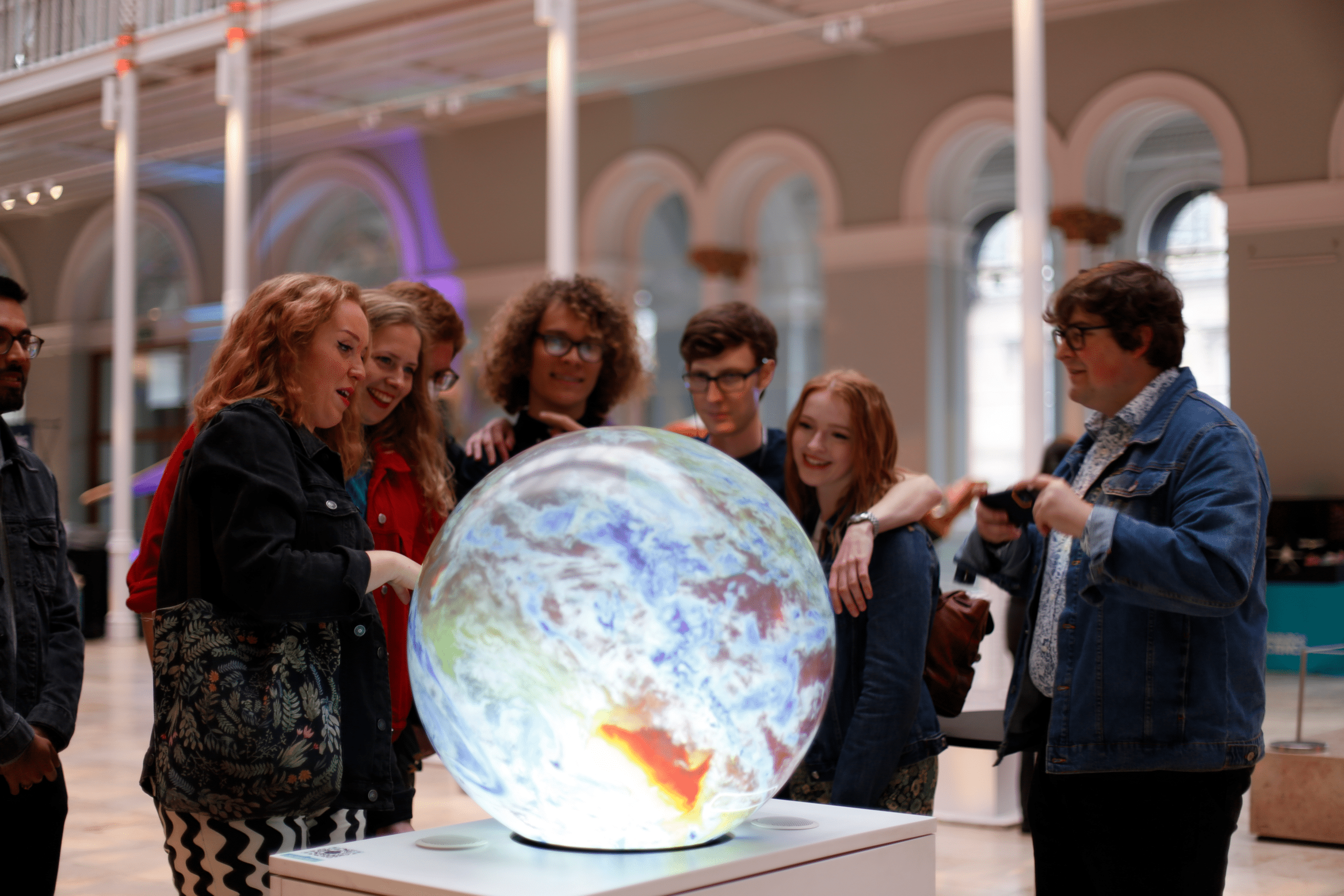 Several visitors exploring an interactive Pufferfish display together