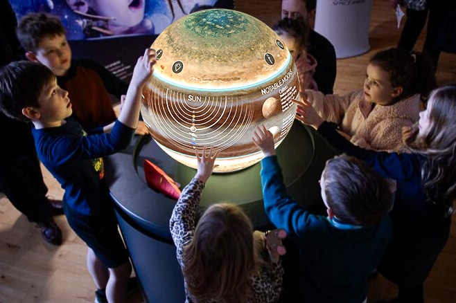 Visitors gathered around a Pufferfish brand activation