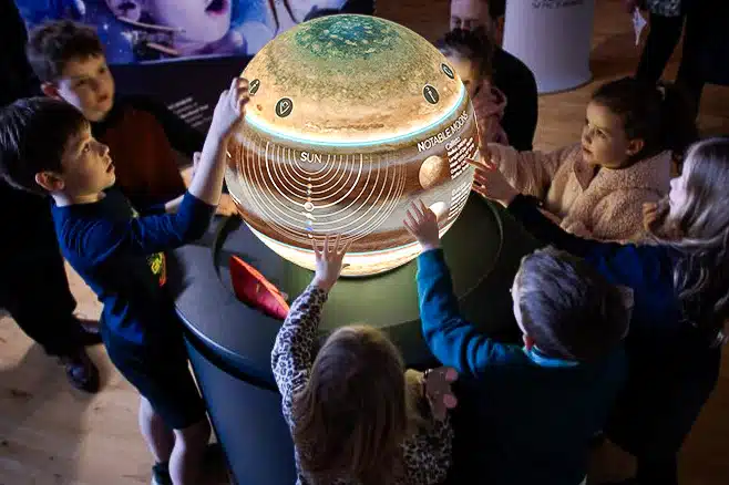 Visitors gathered around a Pufferfish brand activation